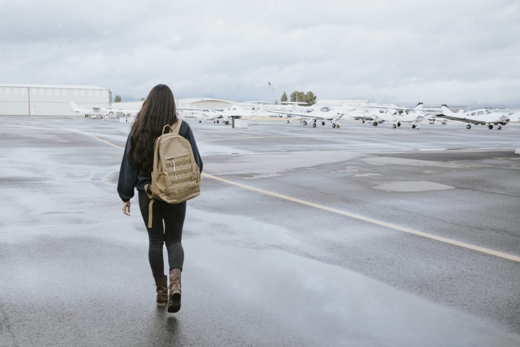 a female pilot walking to planes